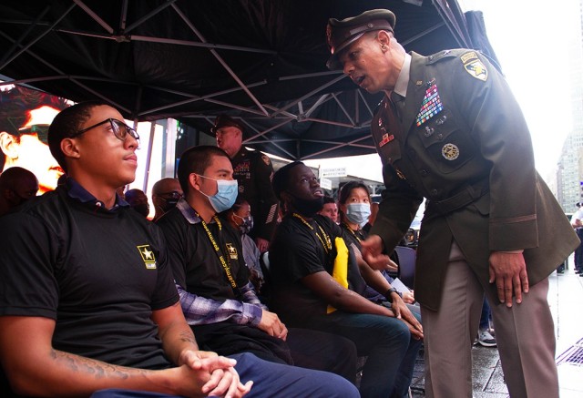 Commandant of Cadets, Brig. Gen. Mark Quander, congratulates new Soldiers who enlisted into the U.S. Army Monday during the 246th Army Birthday celebration at Times Square in New York City.