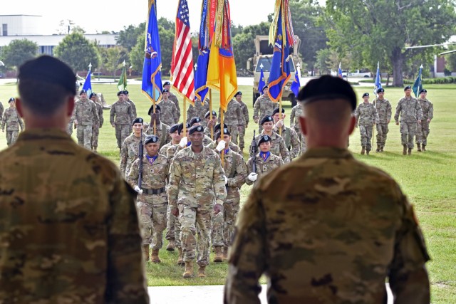 The 1st Aviation Brigade colors march toward the official party during their change of command ceremony at Fort Rucker, Alabama, June 18, 2021. (U.S. Army photo by Lt. Col. Andy Thaggard)