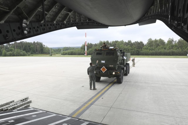 U.S. Army Soldiers assigned to Alpha Battery, 1st Battalion, 77th Field Artillery Regiment, 41st Field Artillery Brigade, drive their High Mobility Artillery Rocket System onto a C-17 Globemaster III aircraft prior to African Lion 2021, at...