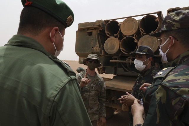 Staff Sgt. Zachary Dohrn, A High Mobility Rocket Artillery System crew member assigned to Alpha Battery, 1st Battalion, 77th Field Artillery Regiment, 41st Field Artillery Brigade, speaks with Moroccan Ground Troops, at Guirer Libouihi Air Base...