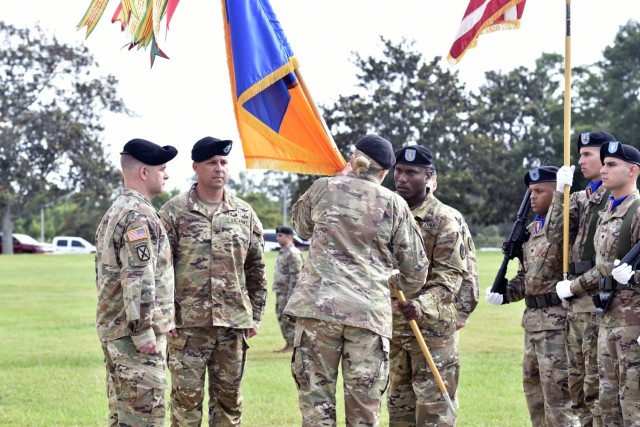 U.S. Army Col. Tammy Baugh holds the unit colors for the last time as commander during the 1st Aviation Brigade change of command ceremony at Fort Rucker, Alabama, June 18, 2021. (U.S. Army photo by Lt. Col. Andy Thaggard)