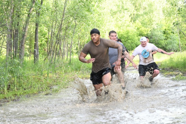 More than 600 community members answered the “call to dirty” on June 18 and completed the annual Mountain Mudder – a 5.5-mile course with 25 obstacles guaranteed to challenge both the mind and body (as well as your laundry detergent!). The Mudder, hosted by Fort Drum Family and Morale, Welfare and Recreation (FMWR) and the Better Opportunities for Single Soldiers (BOSS) program, had twice as many obstacles as last year, and had all the wet, muddy, and even soapy, fun that participants have come to expect every year. (Photo by Mike Strasser, Fort Drum Garrison Public Affairs)