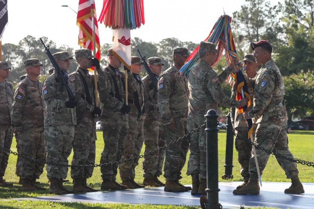 U.S. Army Lt. Gen. Michael Kurilla, commanding general of the XVII Airborne Corps, passes the 3rd Infantry Division colors to Maj. Gen. Charles D. Costanza, incoming commander, during a Change of Command Ceremony, June 21, 2021. Passing the unit colors is symbolic of the transfer of responsibility and command. (U.S. Army Photo by Pfc. Caitlin Wilkins, 50th Public Affairs Detachment)