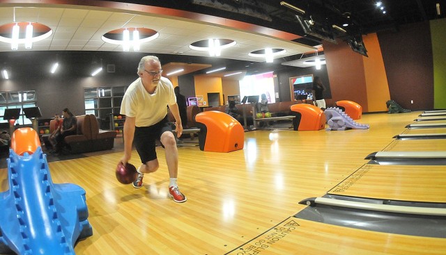 Retired Army Sgt. 1st Class John Graham takes aim at the pins during a relaxing June 17 game at the TenStrike Bowling and Entertainment Center, Fort Lee. It is among the Family and MWR facilities that can resume full-capacity operations with the installation’s change to Heath Protection Condition - Alpha. TenStrike has resumed the following hours of operation: Monday-Thursday, 11 a.m. - 9 p.m.; Friday, 11 a.m. - 10 p.m.; and Saturday and Sunday, 
11 a.m. - 6 p.m. (U.S. Army photo by T. Anthony Bell)