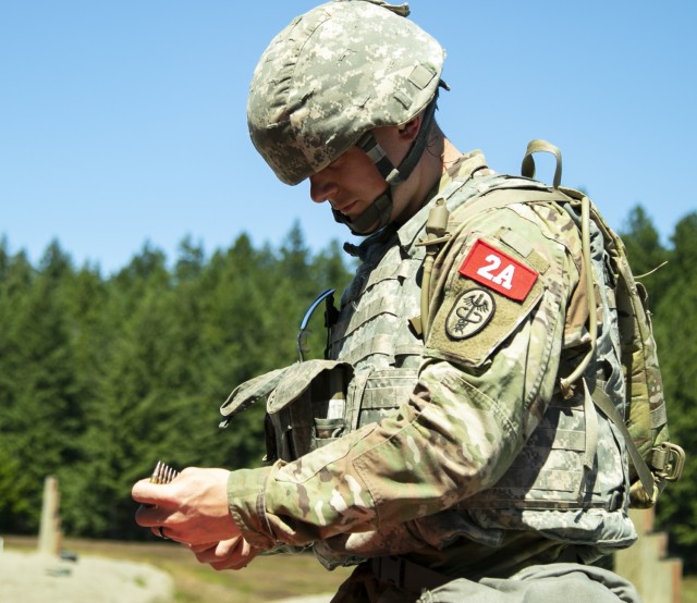 Sgt. Zachariah Storm, a combat medic specialist assigned to U.S. Army Medical Department Activity—Japan, receives ammunition prior to qualifying on the M4 Carbine, as part of the Regional Health Command—Pacific best leader competition, at...