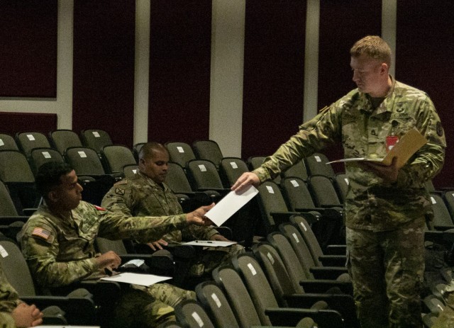 Sgt. 1st Class Justin Reichenbach, the noncommissioned officer in charge of the written examinations and oral board, right, administers the essay portion of the Regional Health Command - Pacific’s best leader competition, at Joint Base Lewis-McChord, Wash., June 15, 2021. This competition will test Army medical personnel as Soldiers and as medics through a variety of events, including an Army Combat Fitness Test, an oral board, and a mystery event during this four-day challenge. (U.S. Army photo by Spc. Richard Carlisi, I Corps Public Affairs)