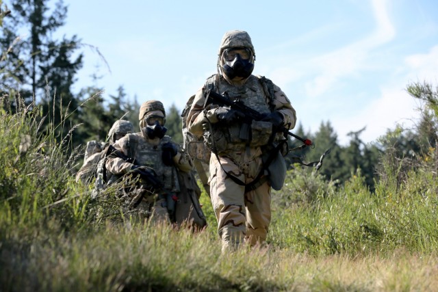 Sgt. Patrick Cook, followed by Capt. Laura Benz and other members of the U.S. Army Medical Department Activity-Alaska team, move across a simulated contaminated area during the Regional Health Command-Pacific Best Leader Competition, Joint Base...