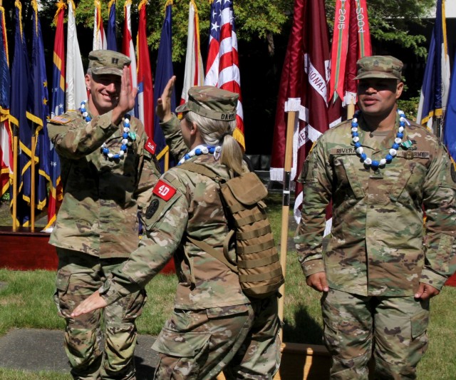 First Lt. Sarah Davis, center, assigned to Tripler Army Medical Center, Honolulu, congratulates Capt. Jason Christman, left, after Christman's team victory in the Regional Health Command-Pacific Best Leader Competition, Joint Base Lewis McChord,...