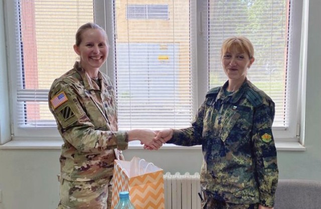 U.S. Army Reserve Lt. Col. Mary J. Durham, commander of the 773rd Civil Support Team, 7th Mission Support Command, left, shakes hands with Bulgarian Army Maj. Natalya Ivanova, commander of the 38th Chemical, Biological, Radiological, Nuclear...