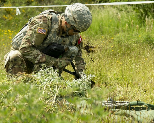 Spc. Christopher Goode, a Soldier with U.S. Army Health Services Command, constructs an individual fighting position during the Regional Health Command - Pacific best leader competition, at Joint Base Lewis-McChord, Wash., June 16, 2021. The second full day of this four-day challenge also included land navigation exercises in addition to constructing individual fighting positions. (U.S. Army photo by Spc. Richard Carlisi, I Corps Public Affairs)