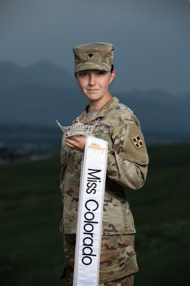 Spc. Maura Spence, a Katy, Texas native and an intelligence analyst assigned to Headquarters and Headquarters Company, 23rd Infantry Regiment, 1st Stryker Brigade Combat Team, 4th Infantry Division, displays her crown and sash after winning first place in the Miss Colorado 2021 pageant, June 8, 2021. Two reasons for Spence’s drive to compete in Miss Colorado and Miss America are to spread awareness for mental health and to keep the memory and dreams of her departed sister alive. (U.S. Army photo by Spc. Matthew Marsilia)