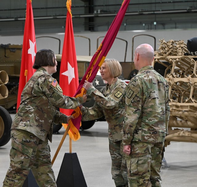 Command Sgt. Maj. Petra M. Casarez, outgoing Ordnance Corps CSM, passes the regimental colors to Brig. Gen. Michelle M.T. Letcher, outgoing chief of ordnance, during a combined relinquishment of command and responsibility ceremony June 21 at the Ordnance Training Support Facility, Fort Lee.