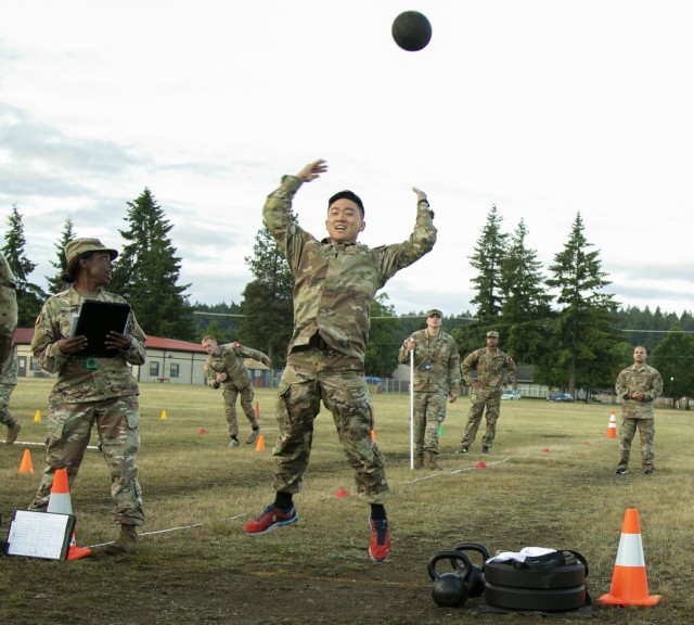 First Lt. Samuel Joo, a medical surgical nurse with U.S. Army Medical Department Activity - Korea, attempts his first of two standing power throws during the Army Combat Fitness Test as part of the Regional Health Command - Pacific best leader competition, at Joint Base Lewis-McChord, Wash., June 16, 2021. The second full day of this four-day challenge also included land navigation exercises in addition to constructing individual fighting positions. (U.S. Army photo by Spc. Richard Carlisi, I Corps Public Affairs)