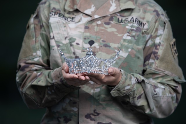 Spc. Maura Spence, a Katy, Texas native and an intelligence analyst assigned to Headquarters and Headquarters Company, 23rd Infantry Regiment, 1st Stryker Brigade Combat Team, 4th Infantry Division, displays her crown after winning first place in the Miss Colorado 2021 pageant, June 8, 2021. Two reasons for Spence’s drive to compete in Miss Colorado and Miss America are to spread awareness for mental health and to keep the memory and dreams of her departed sister alive. (U.S. Army photo by Spc. Matthew Marsilia)