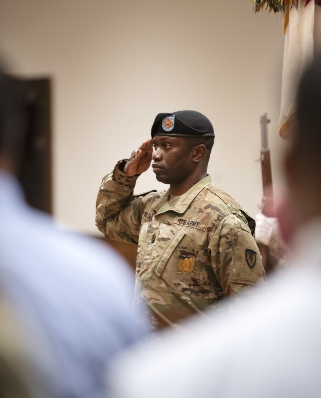 Garrison Command Sgt. Maj. Algrish Williams Sr., salutes during the playing of the National Anthem at the Fort Jackson Garrision change of command ceremony June 15 at Victory Hall on post.