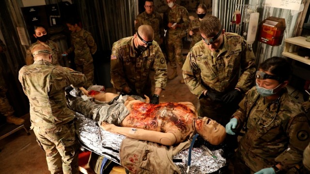Medics with the 1077th Medical Company – Ground Ambulance, Kansas Army National Guard, worked in small teams to assess a mannequin “casualty” as part of the culminating training exercise for the Medic Sustainment 24-Hour course at the...