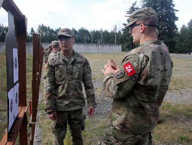 Sgt. Zachariah Storm, right, gives advice on shot grouping to Pfc. Joshua Yi during the Regional Health Command-Pacific Best Leader Competition, June 16, 2021, Joint Base Lewis-McChord, Wash. Storm and Yi are both assigned to U.S. Army Medical...