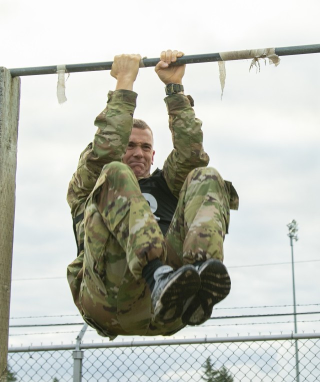 Sgt. Zachariah Storm, a combat medic specialist assigned to U.S. Army Medical Department Activity - Japan, performs multiple leg tucks during the Army Combat Fitness Test, as part of the Regional Health Command - Pacific best leader competition, at Joint Base Lewis-McChord, Wash., June 16, 2021. The second full day of this four-day challenge also included land navigation exercises in addition to constructing individual fighting positions. (U.S. Army photo by Spc. Richard Carlisi, I Corps Public Affairs)