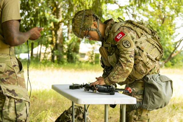First Lt. Samuel Joo, a medical surgical nurse with U.S. Army Medical Department Activity - Korea, assembles and performs a functions check on his M4 Carbine, as part of the Regional Health Command - Pacific best leader competition, at Joint Base Lewis-McChord, Wash., June 16, 2021. The second full day of this four-day challenge also included land navigation exercises in addition to constructing individual fighting positions. (U.S. Army photo by Spc. Richard Carlisi, I Corps Public Affairs)