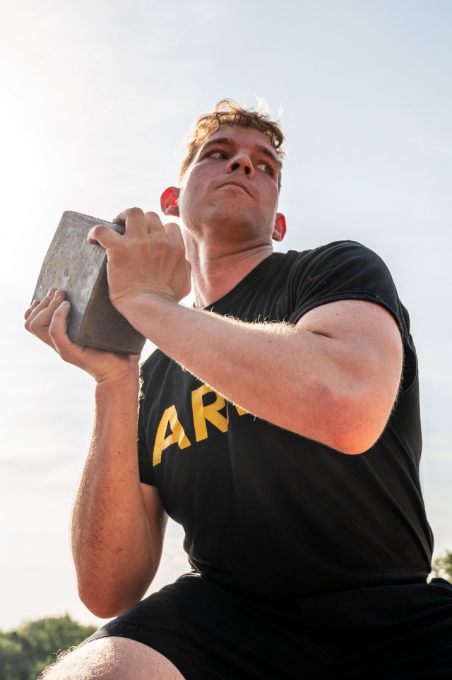 A Soldier prepares to throw a stone during a German Sports Badge event on Panzer Kaserne, Germany, June 19, 2021.