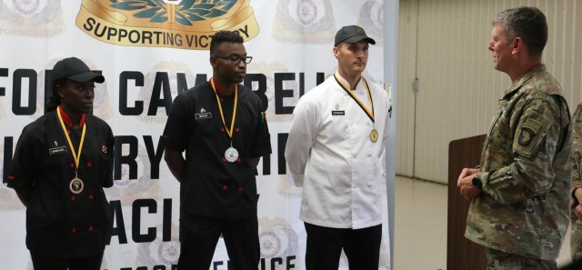 1LT Nickesha Carmichael, SGT Anthony McKoy, and SFC Adam Herrman are congratulated and presented with medals by Commanding General of the 101st Airborne Division, Major General Joseph P. Mcgee. The Soldiers placed in the top three spots of the...