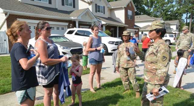 Col. Karin L. Watson and Command Sgt. Maj. Tamisha A. Love speak with residents of the Monroe Manor neighborhood during Fort Lee’s first Walking Town Hall on June 21. The senior garrison leaders were accompanied by representatives of Hunt Military Communities – the company that manages privatized housing here – and staff members from Kenner Army Health Clinic; the Provost Marshal, Religious Support, Garrison Safety and Installation Housing offices; and Family and MWR. The plan is to schedule additional events throughout the coming months so all housing area neighborhoods are visited by the end of the year. (U.S. Army photo by Patrick Buffett)