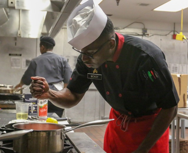 SGT Anthony McKoy, G Company, 1-187 Battalion, 3rd Brigade Combat Team, 101st Airborne Division (AASLT) squeezes lemon juice onto his appetizer during the finals of the 2021 Week of the Eagle culinary competition. This competition gives Soldiers...