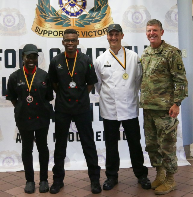1LT Nickesha Carmichael, SGT Anthony McKoy, and SFC Adam Herrman are congratulated and presented with medals by Commanding General of the 101st Airborne Division, Major General Joseph P. Mcgee. The Soldiers placed in the top three spots of the...