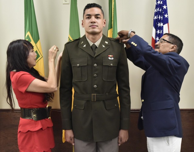 Steven Berrios’ mother, Tess, and father, Edgar, pin on his second lieutenant rank at a commissioning ceremony June 16 at the Military Police Museum Regimental Room. Berrios graduated from the U.S. Military Academy at West Point last month, but wanted to have a ceremony here to thank his family and mentors from the Waynesville High School Junior ROTC program.