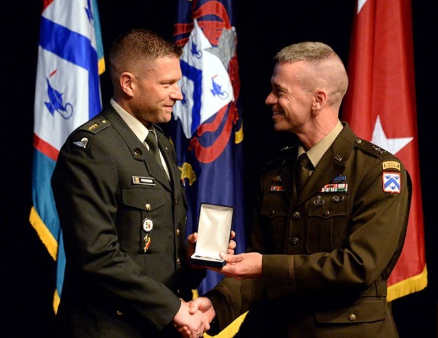 Capt. Robin Frooninckx of Belgium receives the Command and General Staff College International Graduate Badge from Maj. Gen. Donn Hill, CGSC deputy commandant, during the badge presentation ceremony June 17 at the Lewis and Clark Center. Photo by Prudence Siebert/Fort Leavenworth Lamp