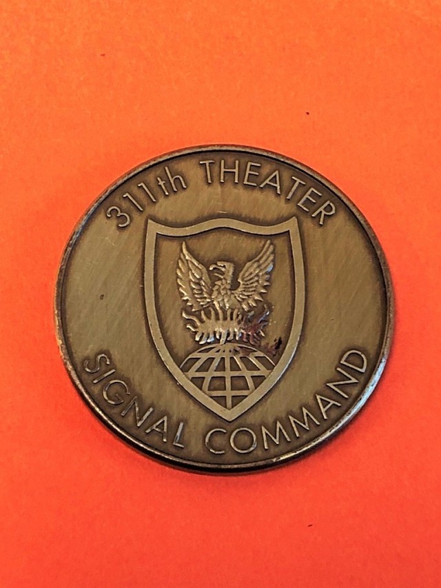 A ceremonial coin from the 311th Theater Signal Command activation ceremony held at Fort George G. Meade, Maryland, June 22, 1996.