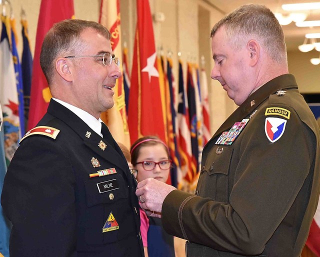 Maj. Gen. Chris Mohan, commanding general, U.S. Army Sustainment Command, and senior mission commander, Rock Island Arsenal, Illinois, awards Lt. Col. Jeff Milne the Legion of Merit during the RIA quarterly retirement ceremony June 23 at Heritage...
