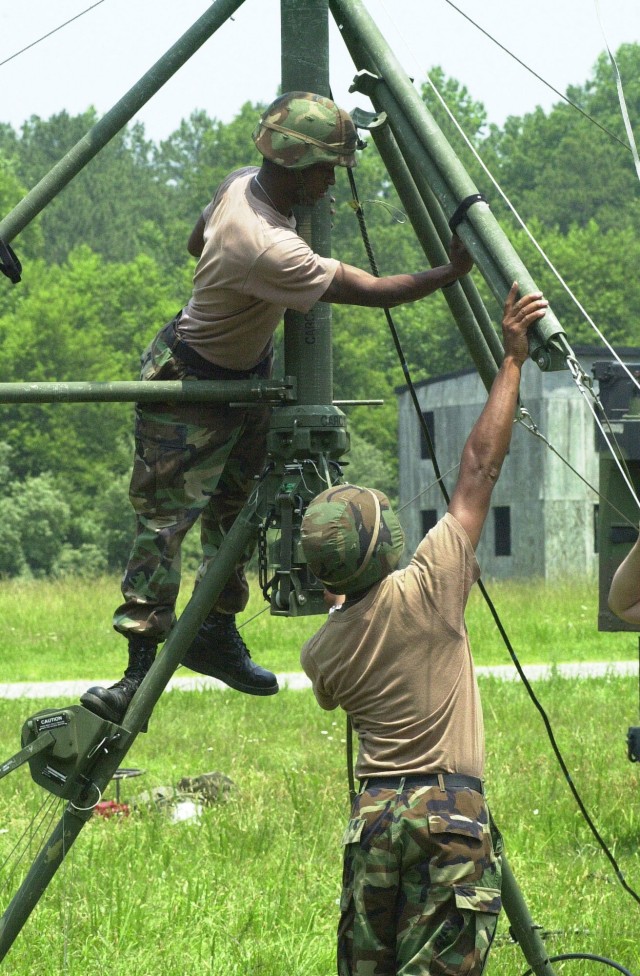 Sgt. Gerald Mosely and Sgt. Micah Frasier prepare to crank up A DAMPS Antenna, which is set to receive communications at Fort AP Hill, Virginia on June 13, 2001.  Mosely and Frasier are assigned to the 67th Signal Battalion, Fort Gordon, Georgia. Soldiers from the 93rd Signal Brigade are participating in Grecian Firebolt, an Army communications exercise, which is being conducted throughout the world from June 12 through June 30th, 2001.