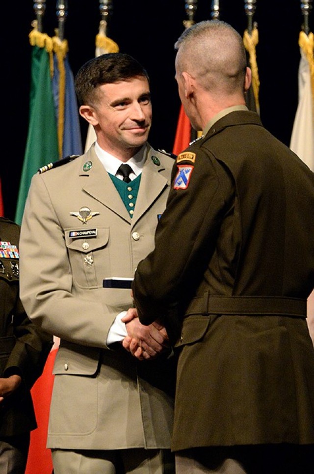 Lt. Col. Nicolas Champeval of France receives the Command and General Staff College International Graduate Badge from Maj. Gen. Donn Hill, CGSC deputy commandant, during the badge presentation ceremony June 17 at the Lewis and Clark Center. Photo by Prudence Siebert/Fort Leavenworth Lamp