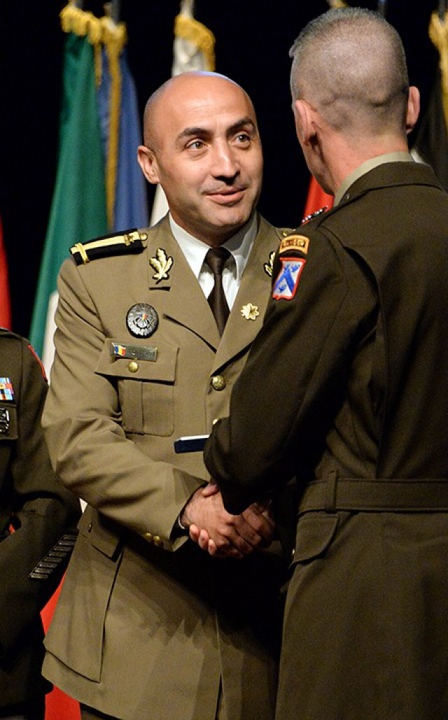 Maj. Florin Botezan of Romania receives the Command and General Staff College International Graduate Badge from Maj. Gen. Donn Hill, CGSC deputy commandant, during the badge presentation ceremony June 17 at the Lewis and Clark Center. Photo by Prudence Siebert/Fort Leavenworth Lamp