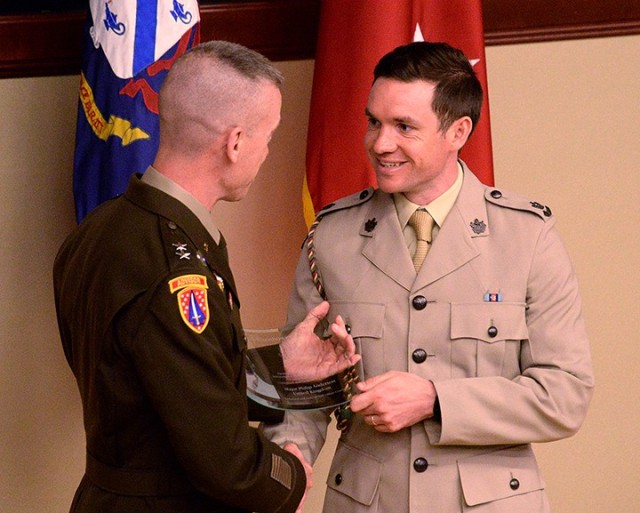 Maj. Gen. Donn Hill, deputy commanding general for education, Combined Arms Center, presents the Gen. Dwight D. Eisenhower Award to distinguished international graduate Maj. Philip Anderson of the United Kingdom during the Command and General...