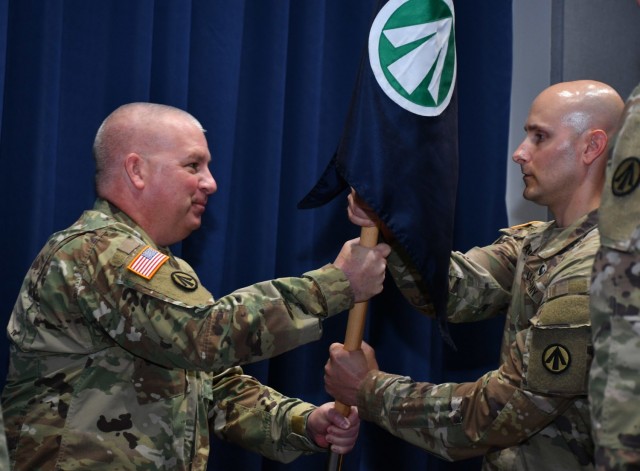 Col. Stephen York, Military Surface Deployment and Distribution Command chief of staff, hands the command guidon to Capt. Clinton Allen, the command's new Headquarters and Headquarters Detachment commander June 24, 2021 on Scott Air Force...
