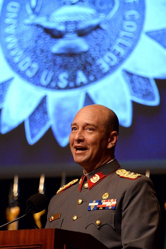 Lt. Col. Gonzalo Lopez of Chile, international military student chief of staff, provides remarks as a slide showing the Command and General Staff College International Graduate Badge is projected behind him during the IMS badge presentation ceremony June 17 in Eisenhower Auditorium at the Lewis and Clark Center. Photo by Prudence Siebert/Fort Leavenworth Lamp