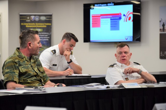 USASAC Commander Brig. Gen. Garrick Harmon (right) meets with a Security Assistance Liaison Officer Lt. Col. Athanasios Natsios of Greece&#39;s Hellenic Army (far left) and USASAC’s SALO Manager Terra Good (not pictured) during a June 16 visit to the command’s New Cumberland, Pennsylvania-based headquarters. USASAC currently hosts 16 SALOs from 13 partner nations. Each SALO works closely with USASAC employees to ensure the successful execution of FMS cases on behalf of their countries.