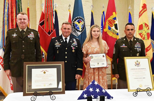 Maj. Gen. Chris Mohan, commanding general, U.S. Army Sustainment Command, and senior mission commander, Rock Island Arsenal, Illinois, and Command Sgt. Maj. Marco Torres, ASC, stands with Maj. Clayton Degenhardt and his daughter, after receiving...