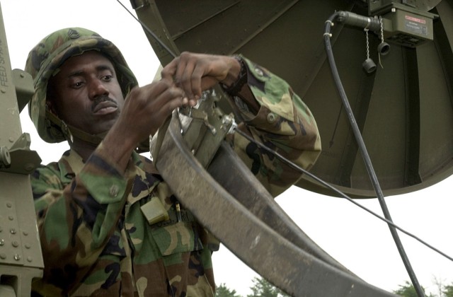 Sergeant 1st Class Stanley Johnson of the 259th Signal Company (TROPO) (Army National Guard) stationed at Harrington, Delaware, is mounting wave guide cables to the messenger cables while setting up communications operations at Crusader Park using the Transpheric Scattering Long Haul Line of Sight Communications System.  Grecian Firebolt is the Army's largest Communications Exercise since WWII; the exercise begins June 12, 2001 and ends on June 30, 2001.  The largest peacetime global communications exercise in the world, Grecian Firebolt 2001 (GF 01), with Active Army, Reserve, and Army and Air National Guard units connecting 28 locations throughout the US and Asia.  (U.S. Army photo by Sgt. Kyran V. Adams) (RELEASED)