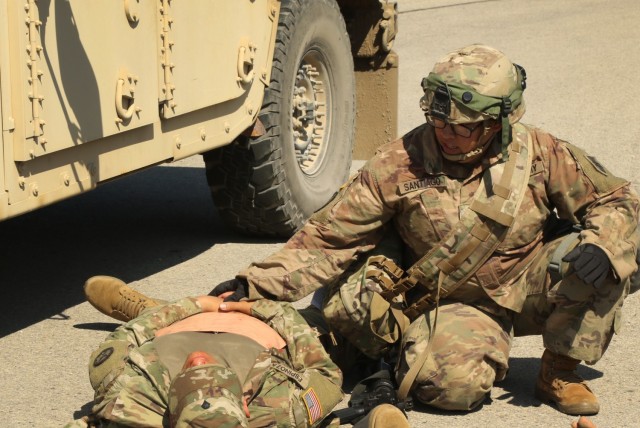 Staff Sgt. Santana Santiago treats a simulated casualty after a simulated attack during Warrior Exercise 86-21-02 on Fort McCoy, Wis., June 11, 2021. Santiago is assigned to 2nd Platoon, 702nd Engineer Company from Johnson City, Tenn., and is here for annual training. WAREX is a large-scale training exercise consisting of tactical  training scenarios specifically designed to replicate real-world missions. WAREX 86-21-02 serves  as a reinforcement of warrior tasks and skills and allows the unit to further build their  teams. (U.S. Army Reserve photo by Sgt. Juan F. Jimenez, 364th TPASE)