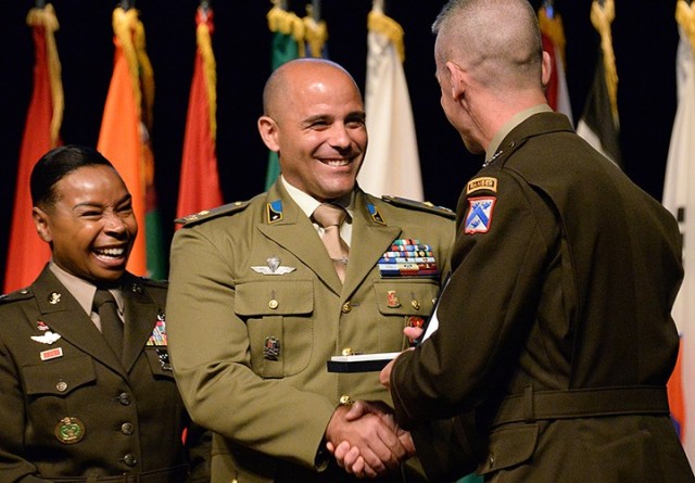 Maj. Giorgio Giosafatto of Italy receives the Command and General Staff College International Graduate Badge from Maj. Gen. Donn Hill, CGSC deputy commandant, assisted by Army University Command Sgt. Maj. Faith Alexander, left, during the badge presentation ceremony June 17 at the Lewis and Clark Center. Photo by Prudence Siebert/Fort Leavenworth Lamp