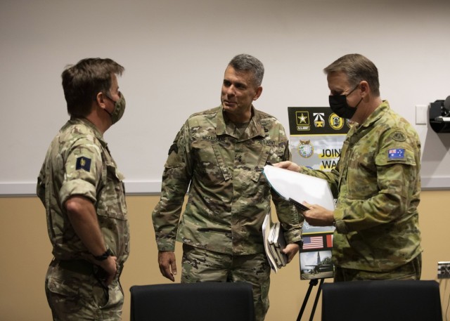 Maj. Gen. Matthew McFarlane, Commanding General, 4th Infantry Division, center, speaks to Brigadier Sam Humphris, Commander, 1st U.K. Brigade (left) and Brigadier Jason Blain, Commander, Australian 7th Combat Brigade (right) prior to the start of the Joint Warfighting Assessment 21 media round table event at Fort Carson, CO, June 24, 2021. The Joint Warfare Assessment is the Army’s annual modernization live field experiment/exercise to demonstrate and assess Multi Domain Operations Concepts, Capabilities, and AimPoint Formations at Echelon. (U.S. Army Photo by Spc. Tenzing Sherpa)