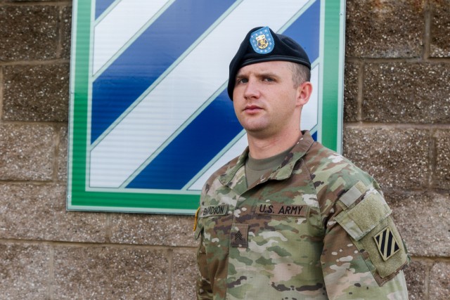 Sgt. Hunter Davidson, a 24-year-old Covington, Georgia native and infantryman assigned to 3rd Battalion, 15th Infantry Regiment, 2nd Armored Brigade Combat, 3rd Infantry Division, poses for a picture in front of a 3rd ID patch on Fort Stewart,...