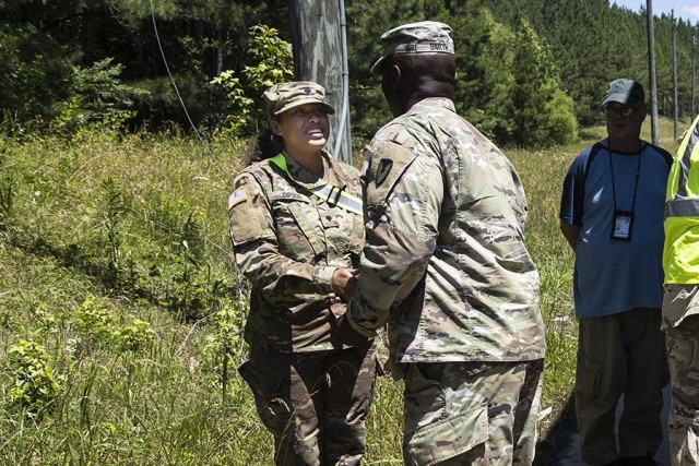 Lt. Col Thomas Smith, Anniston Munitions Center commander, presents a Commander’s Coin for Excellence to a Solider from the Alabama Army National Guard’s 781st Transportation Company. 