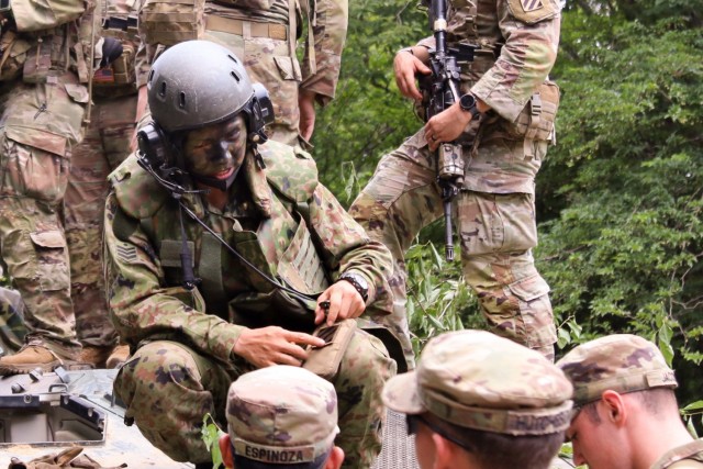 U.S. Army Soldiers of 1st Battalion, 28th Infantry Regiment “Black Lions,” 3rd Infantry Division, give a 3rd Infantry Division unit patch to a member of Japan Ground Self-Defense Force’s 15th Rapid Deployment Regiment June 25, 2021, on Aibano Training Area, Japan, during bilateral training as part of exercise Orient Shield 21-2. Exercise Orient Shield marks a continued commitment by the United States and Japan to work as dedicated partners in support of the Japan-U.S. security alliance and for peace and stability in the Indo-Pacific region.