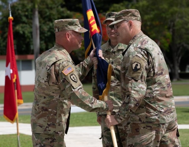 FORT BUCHANAN, P.R— Brig. Gen. Jeffrey W. Jurasek, the senior federal Army officer in the Caribbean, turns Command Sgt. Maj. Michael Meunier his senior enlisted advisor at a change of responsibility ceremony at Fort Buchanan, Puerto Rico, June...