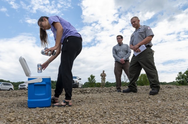 Julie Miller (left), park rangers for the U.S. Army Corps of Engineers Pittsburgh District playing the role of a disorderly visitor, picks up empty cans of alcohol during a training scenario that required Andrew Schwab and Tim Hough to respond at...