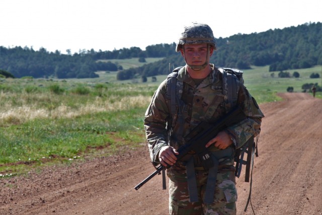 Specialist Charlie Baltzegar, a satellite payload controller, from Echo Company, 53rd Signal Battalion, U.S. Army Satellite Operations Brigade (SATOPS) conducts a 12-mile road march as part of the SMDC Best Warrior competition (US Army Photo by...